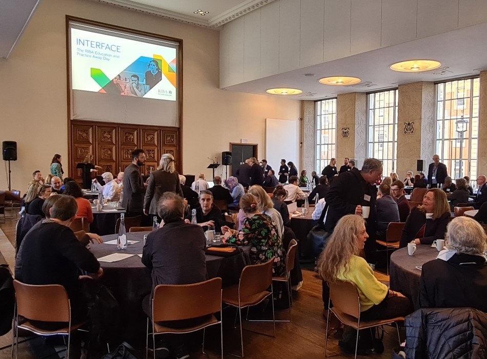 Groups of professionals seated at round tables at Interface conference 2023 at 66 Portland Place