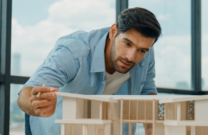 Architect looking a student model at a graduate show GC LARGEjpg