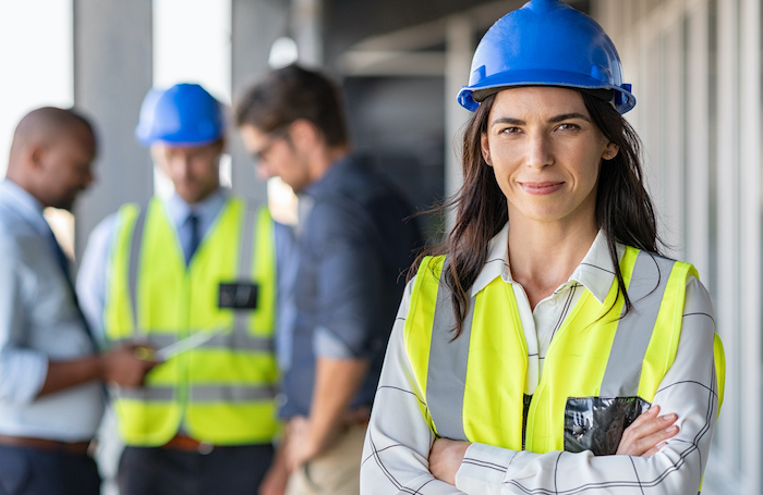 Female architect wearing a highviz and a hard helmet on a building sitejpg