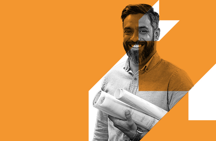 RIBA Architect holding design drawings smiling to the camera BIGjpg