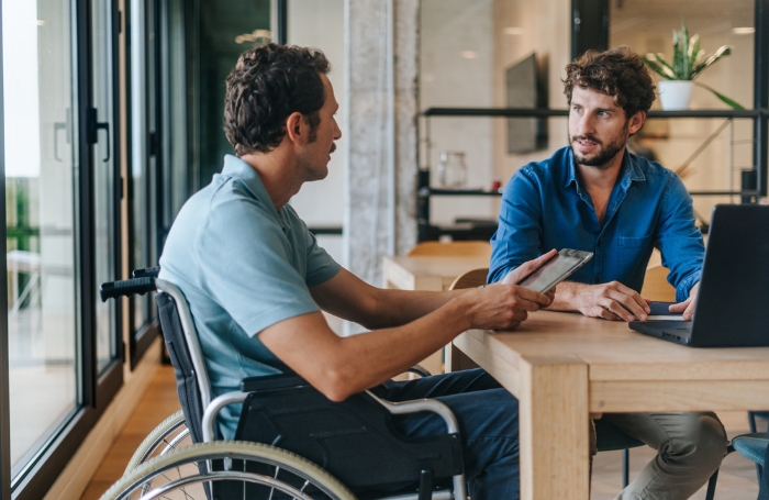 Wheelchair user in a meetingin an officejpg