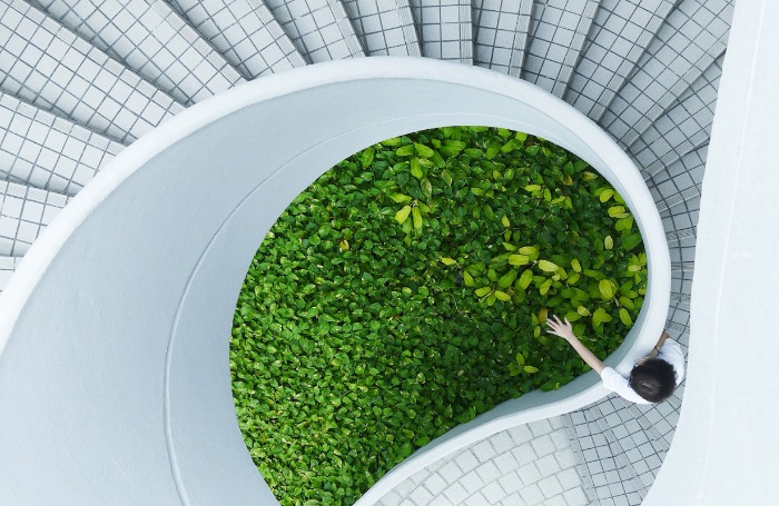 woman standing spiral stairsadobespark 700 x 455jpg