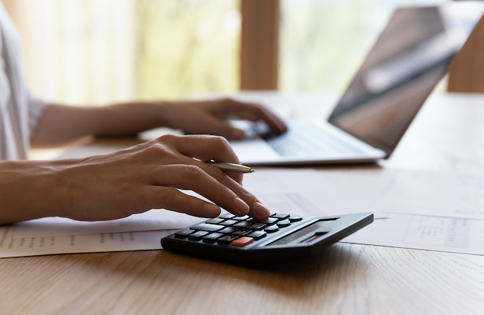 A calculator used by an office worker as they try to set fees and budgetsjpg