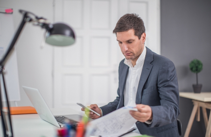 Architect sitting behind a desk looking at papersjpg