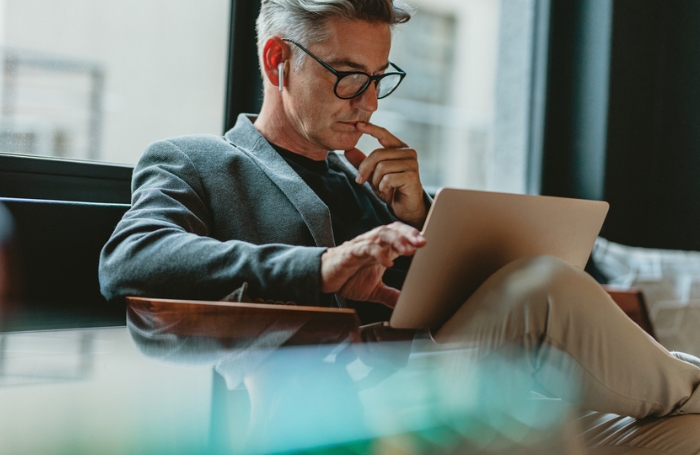Architect wearing glasses reading laptop GC LARGEjpg