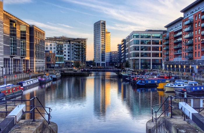 Leeds city centre with highrise buildings refelcting off the water in the dockjpg