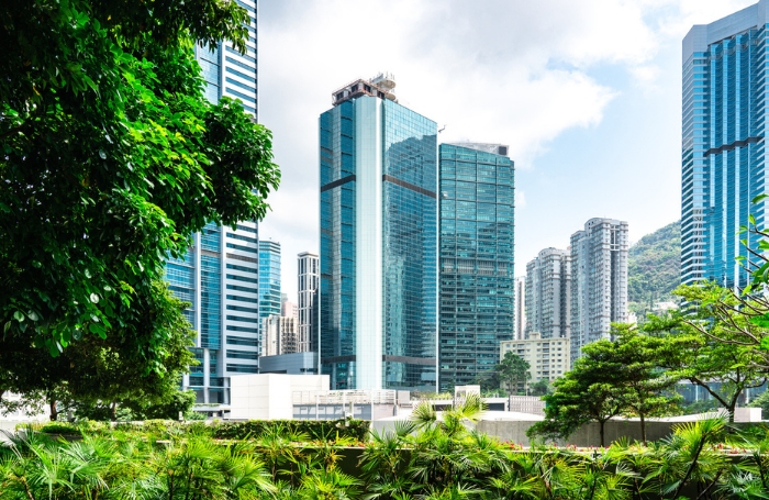 Modern apartment blocks in the background with green tress in the foreground GC LARGEjpg
