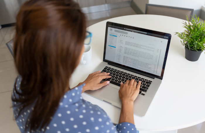 Woman amending an online contract on a laptop 700x455png