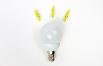 Three yellow pegs fan out above a lightbulb