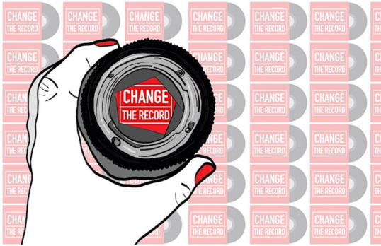 Illustrated graphic of a hand holding an optical glass magnifier over a sheet of 'Change the Record logos' with one logo in the viewer