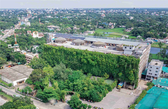 Aerial view of Green Field, a modern building with the entire front covered in plants.