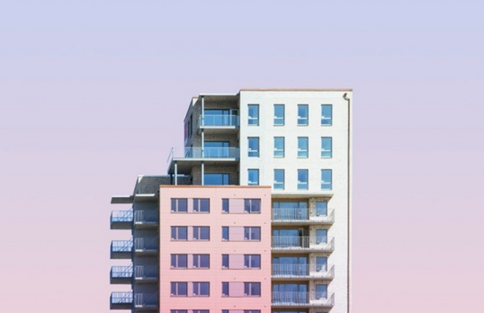 Colourful high rise building against a purple sky