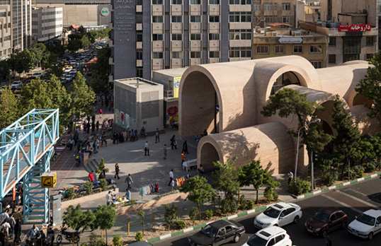 Large beige arches and tunnels connected together in a plaza.