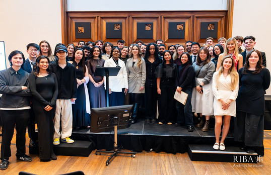 Student award ceremony with winners and nominees standing on a small stage