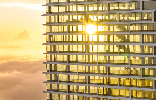 Sunlight hitting a multi storey glass building