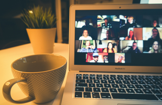 cup of coffee and online meeting on laptop