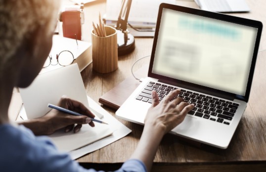 Person typing at a laptop