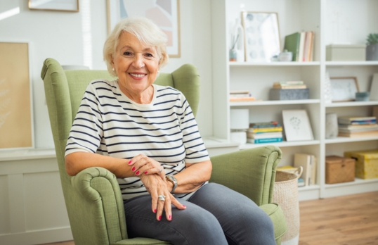 Woman from the older generation in a specious modern living room