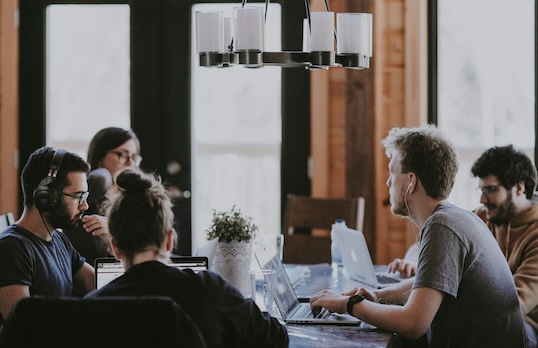 Group of people around a table having a meeting