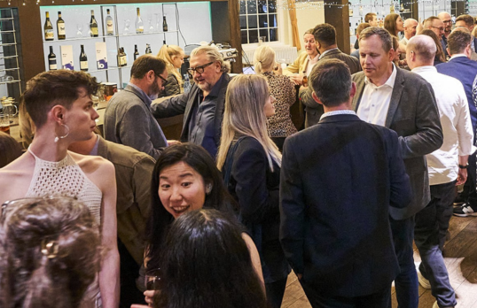 People socialising at a bar during a RIBA North West social