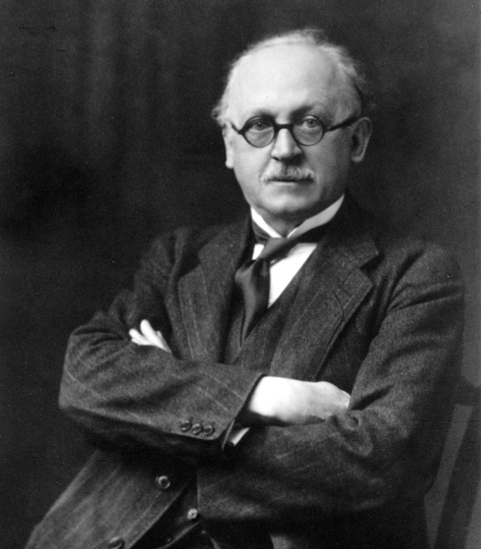 Black and white image of Sir Edwin Lutyens in a suit, wing-collar and tie