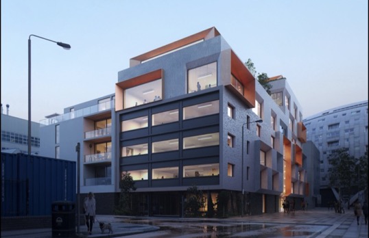A modern building with metallic clad projecting square bays and full width windows facing the street.