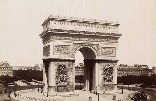 Sepia photograph  of l'Arc de Triomphe in Paris - a large rectangular base with flat top and tall arch through the middle