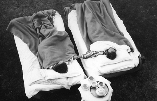 Architecture Partners - two people in bed with blankets outside