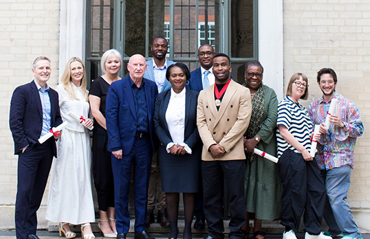 RIBA Honorary Fellows 2024 group in front of a window at 66 Portland Place