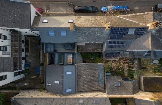 Birdseye view of a row of terraced houses in urban surroundings.