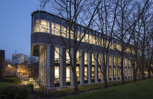 Curved ended concrete office block with trees