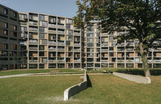 Multi storey concrete housing estate with coloured cladding panels