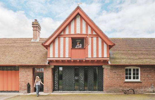 Historic brick stable building with wooden post and beam style upper floor