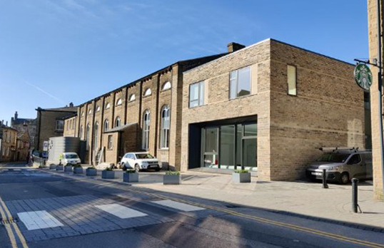 Low rise industrial building with modern square brick extension