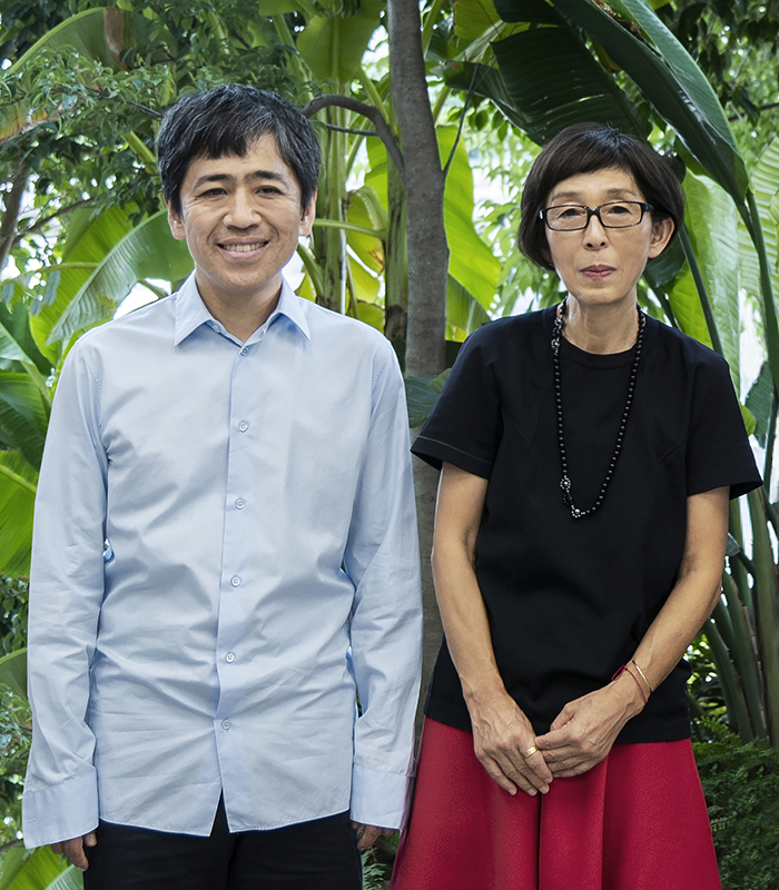 SANAA's Sejima and Nishizawa stood in front of tropical leaves