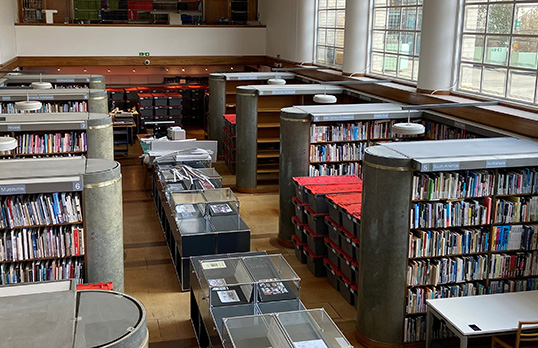 RIBA Library interior with a few empty shelves as books are boxed up for the move
