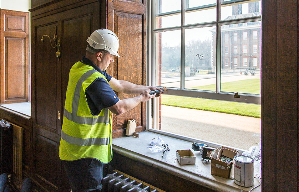 Royal Hospital, Chelsea, London: a worker refurbishing the sash windows