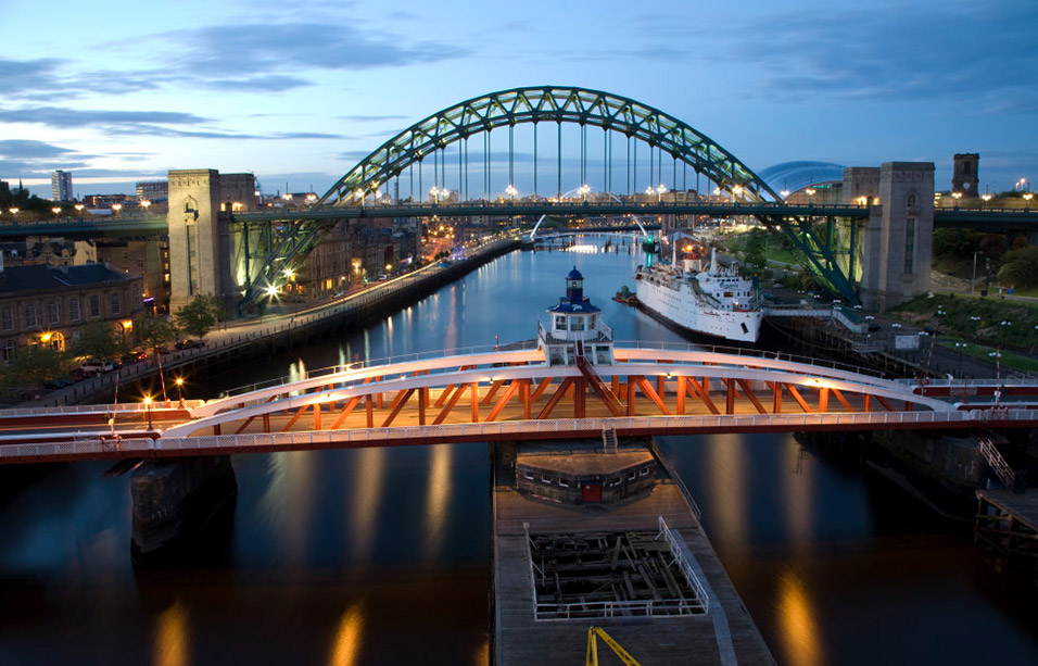 The Swing Bridge and the Tyne Bridge over the River Tyne between Newcastle-upon-Tyne (left) and Gateshead (right) at dusk