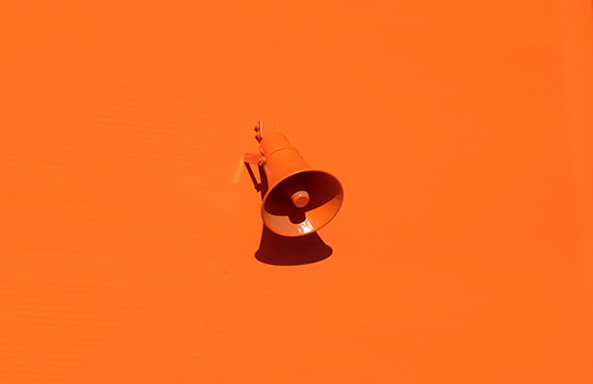 Megaphone on orange background