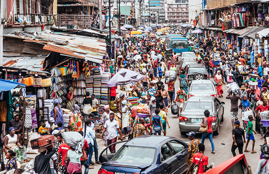 A busy street market with people and cars in Lagos, Nigeria