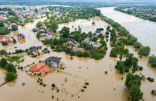 Aerial view of a flooded area with houses and trees partially under water