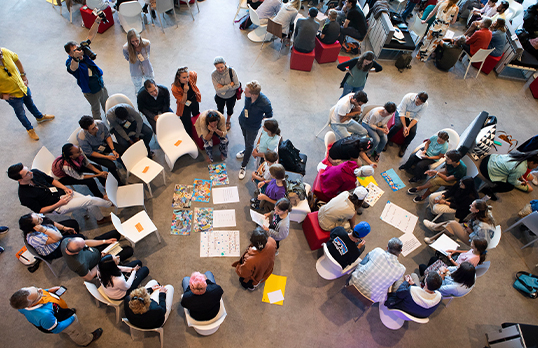 Aerial view of adults and children sitting in circles doing an activity