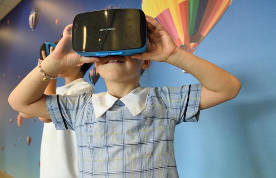 Child holding a VR headset 