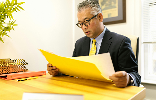 Man in a suit looking at documents