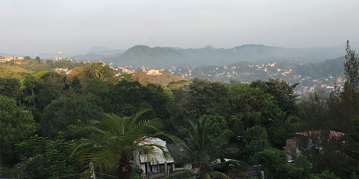 Aerial view of tropical trees and hills surrounding the city of Kandy, Sri Lanka