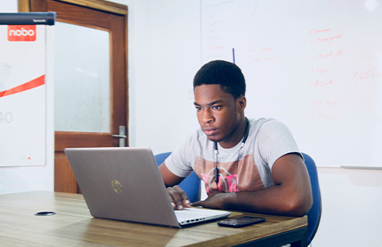 Teenage boy looking at a laptop
