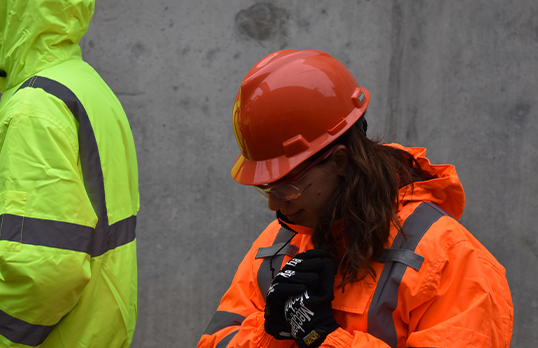 Woman in hi-vis jacket and hard hat