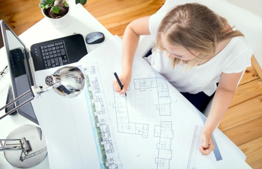 Female architect drawing a floorplan