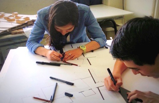 Two architects drawing a floor plan
