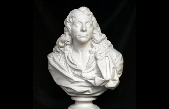 White marble bust of Sir Christopher Wren with long curly hair and draped cloth against a black background